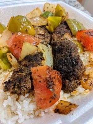 Kofta Kabob dinner entree. Marinated ground beef with grilled onions, bell pepper, and tomato over special homemade rice. $14.25.