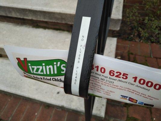 Vizzini's flyer under "No flyers please" sign.