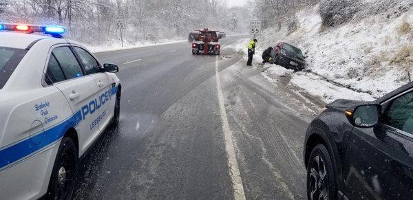 Local police assist with traffic lane control to help Double D towing extract our Jeep from the ditch