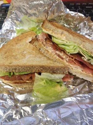 Freshly cooked bacon, fresh lettuce and tomato on toasted rye with copious amounts of chipotle mayo