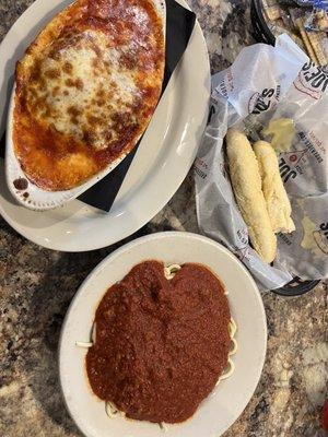 Chicken Parmesan, "side" pasta with meat sauce and two bread sticks.