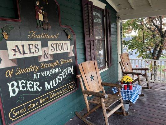 Front porch with tables and rocking chairs