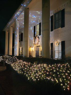 View from walkway of holiday lights projected on the front. Very cute and festive!