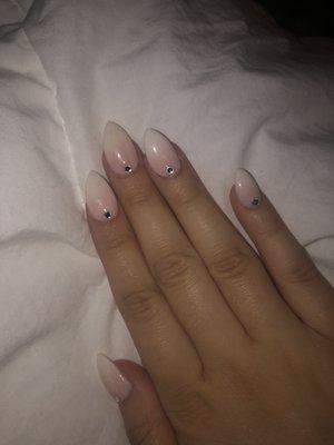 Almond/stiletto tip ombré with pink sparkles and white tips and gems