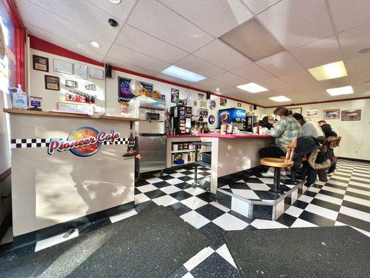 Front entrance with the host area to the left and cafe counter to the right.