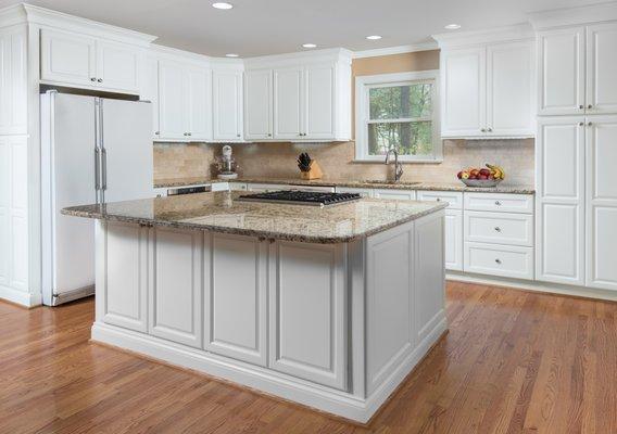 Simple white kitchen with grantie counter tops.