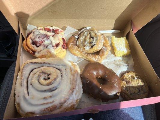 Cinnamon roll, fried cinnamon roll, chocolate covered donut, chocolate chip cookie, lemon bar, and black cherry fruit roll