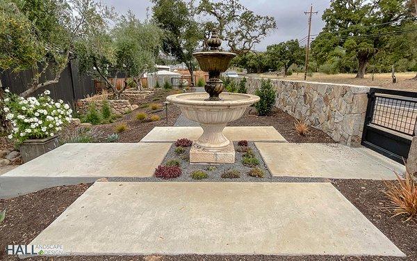 Classic water feature with poured in place concrete gives this courtyard a charming feel.