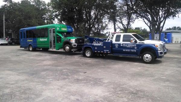 One of our trucks towing a local National Alamo car rental bus