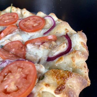 Popeye Pizza with Tomatoes, Chicken, Red Onion, and Spinach on a Pesto-Alfredo Sauce - The Blind Onion Pizza & Pub