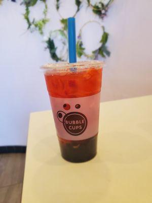 Strawberry green tea with boba.