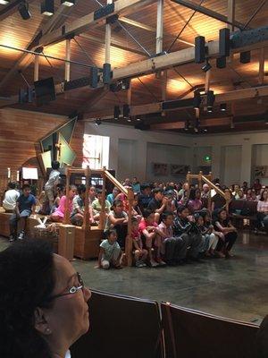 All the children are invited to come and sit around the altar to watch a baptism.