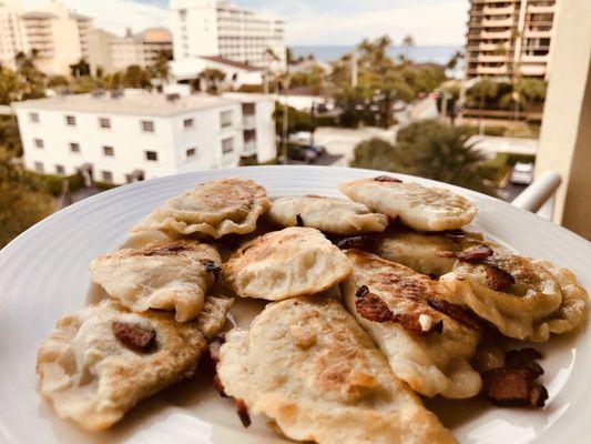 Homemade spinach feta pierogis.   We boiled them and then sautéed with their Gypsy bacon. Very delicious while enjoying the view.