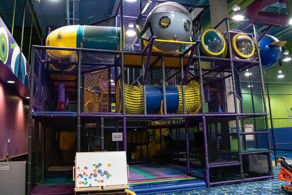 The Quest is a spectacular, multi-storied, indoor play piece consisting of tunnels, tubes, slides, and various physical challenges for kids