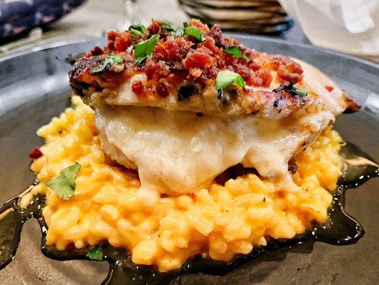 Pancetta covered chicken dish over risotto