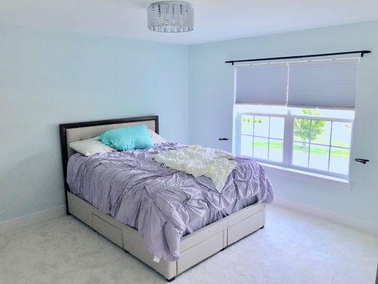 Curtain rods, blinds, a new chandelier and bed. Who wouldn't like sleeping here?