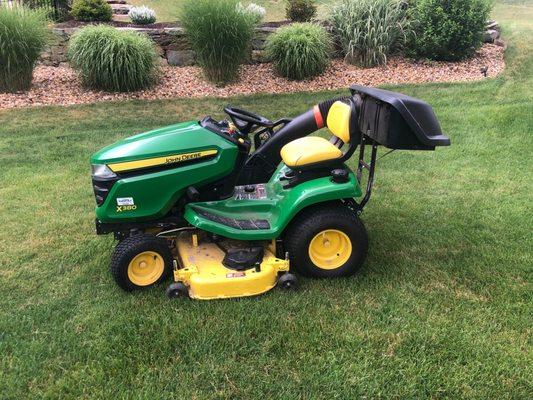 My awesome John Deere x380 with serviceable transmission and power flow bagging system and striping kit