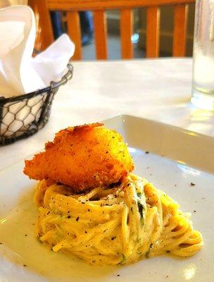 Guanciale and fried poached egg over spaghetti.