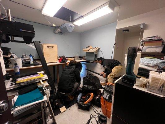 The crew removing wet sheet rock in my photo darkroom.