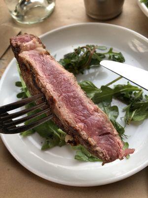 Inside of medium-rare ribeye steak. It wasn't served hot enough but it was well-seasoned. Quality of the meat is so-so.