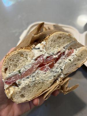 Sesame bagel with pickled shallot schmear and tomatoes.