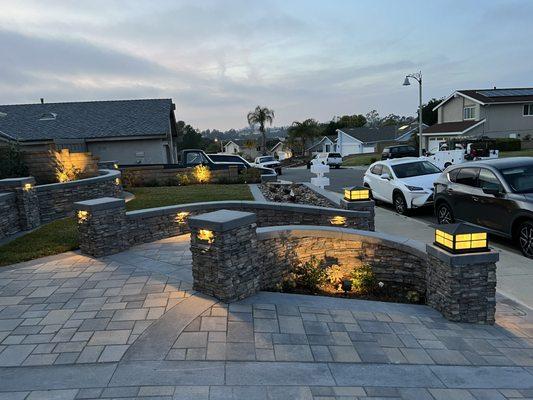 New interlock pavers plus chemical finish concrete surrounding the pavers.  New outdoor lighting and low maintenance front yard.