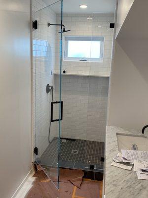 Culver City jobsite. 1/2" Starfire Ultra Clear tempered glass shower door. Matte Black Hardware.