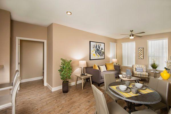 Living room and dining room with plank flooring at Southern Ave Villas