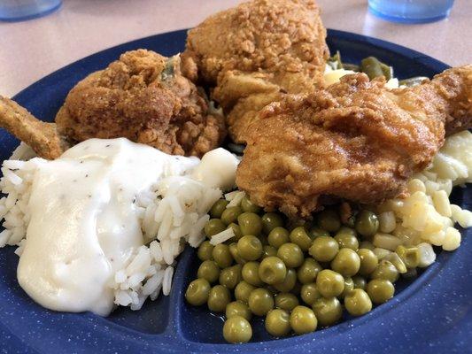 Southern Fried chicken, rice and a white gravy, sweet peas, mashed potatoes, sweet corn