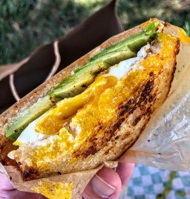 One of the best egg sandwiches you can get anywhere near, pictured with avocado instead of bacon and served on their unique semolina bread.