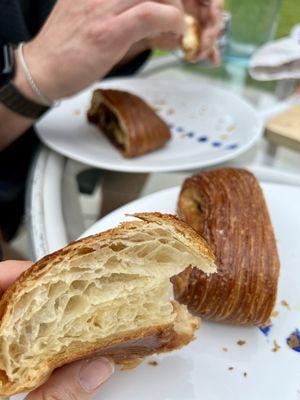 Traditional croissant with a pan suisse in the background