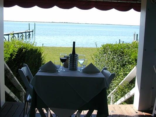 Outdoor seating with panoramic bay views. Award winning food from the Hamptons first Platinum Chef.