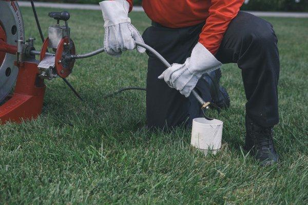 Technician snaking the sewer lines of a customers home. Snake, Sewer, Lines, Drains