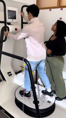 Dr. Tolentino w/patient on the Huber 360 working safely on both physical and cognitive skills: low back pain, neuro-rehab, physical activity