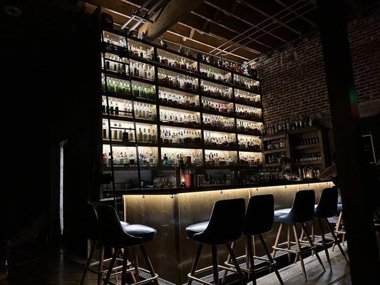 Toward closing time. Very classy, nicely lit bar with library ladder, exposed brick and pipe.