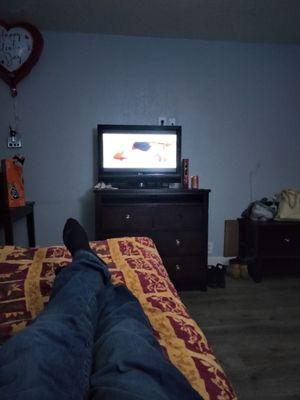 Watching TV in a big bed