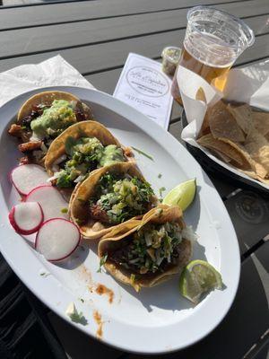 Birria, Al pastor and Carnitas tacos with beer