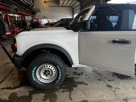 Showing me my new tire in the shop to make sure I like it first.