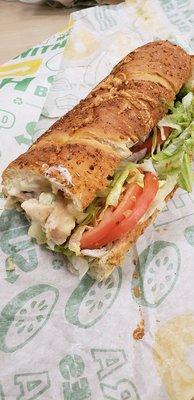 This is a 12" Italian cheese and herb with chicken chucks, cheese, guacamole, lettuce and tomato, heated up...