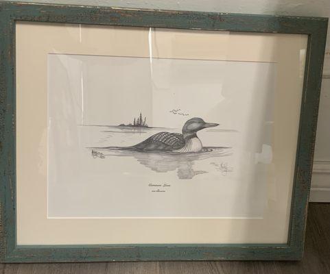 Duck in pond drawing with an off white matting and a blue rustic frame. This frame will add so much character into the room.