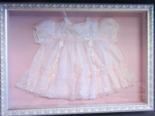 Shadowbox of young girls dress.