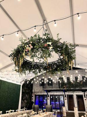 Chandelier on the patio, decorated with florals from Wild Botanical