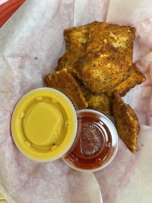 Fried ravioli with cheese sauce and marinara.