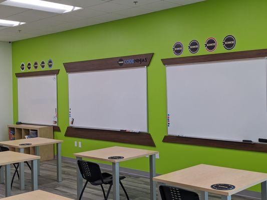 Dojo has three whiteboards, 10 tables, and computers for the Ninjas to work on.