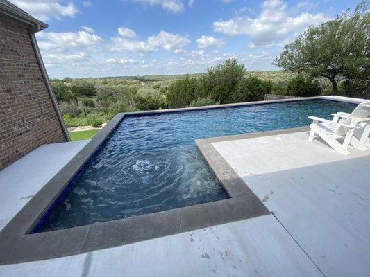 Charcoal color Coping had a modern look! Ocean Blue Pebble Sheen pool finish is the right color for us! Time to splash!