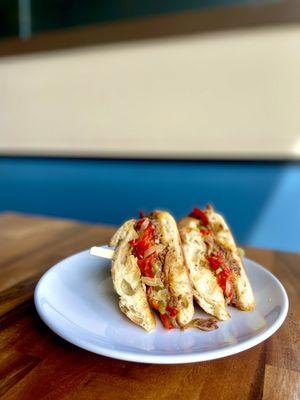 Braised Beef Philly--

Spiced slow roasted beef, roasted garlic aioli, mixed peppers & onion, provolone, garlic baguette