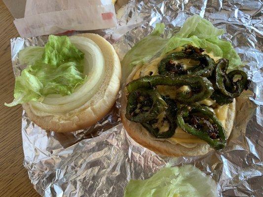 Cheese burger with grilled jalapeños, lettuce, and onion