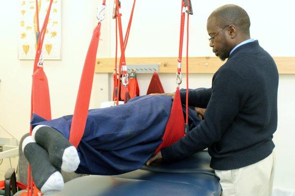 The PT, Abdoulaye Ndaw working with a patient on the Redcord.