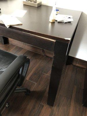 Large desk with leg unattached gravity holding it together