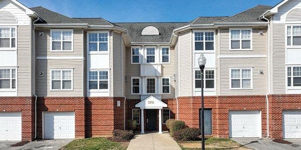 a row of town houses with a sidewalk in front of them